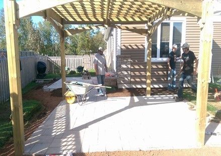 Worker is Standing Under a Wood Pergola – Calgary, AB – As The Sod Turns Landscape & Design Inc. Worker is Standing Under a Wood Pergola – Calgary, AB – As The Sod Turns Landscape & Design Inc.