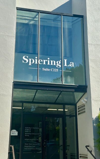 Entrance to Spiering Law office with blue glass awning and door, Suite C225 sign visible