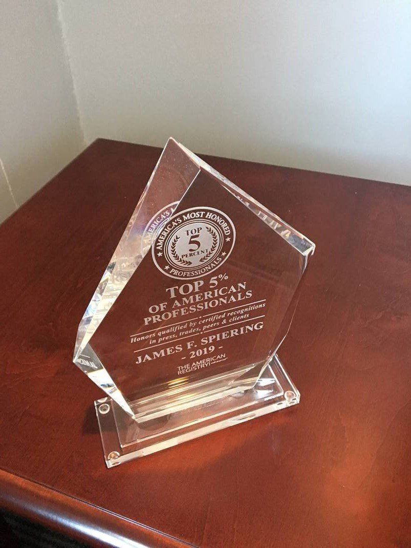 Acrylic award on a dark wooden surface. 