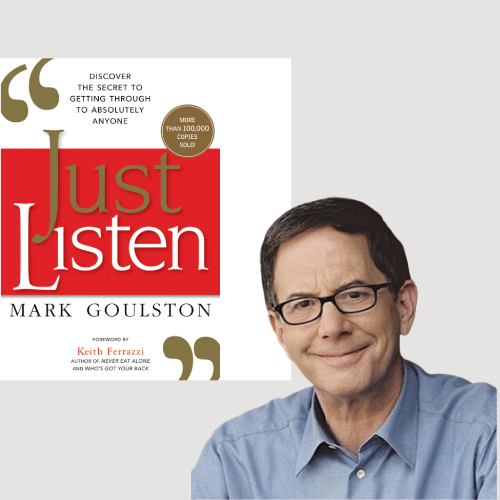 A man is standing in front of a book called just listen