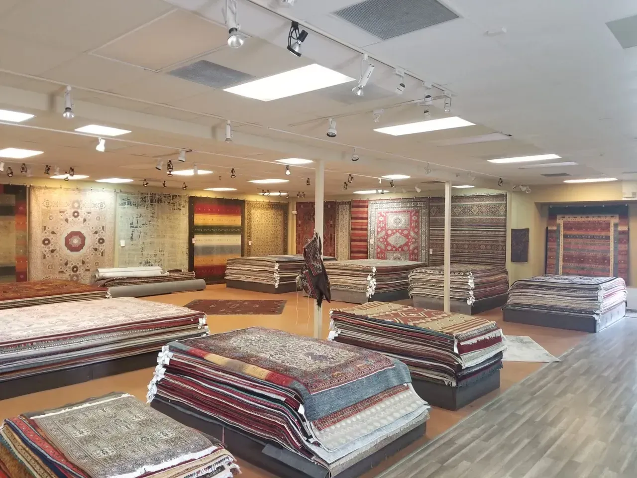 A large room filled with lots of rugs and carpets.