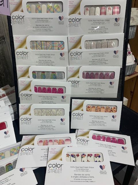 Display of boxed Color Street nail polish strips in various pastel and bright designs.