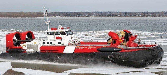 Red and white hovercraft speeding across icy water with crew aboard