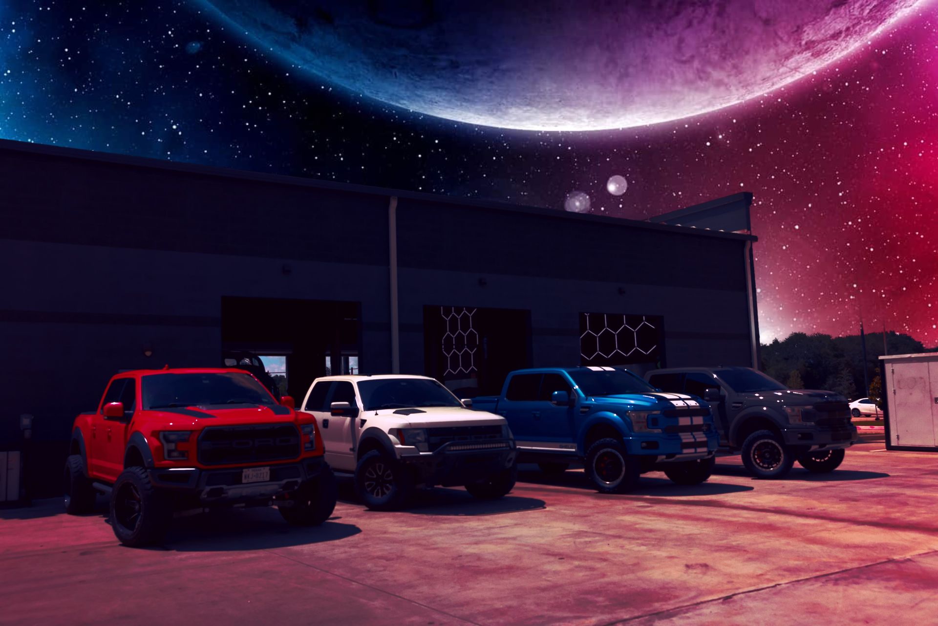 Four lifted Ford Raptor trucks parked outside a building with a colorful space-themed background. | Auto Motive