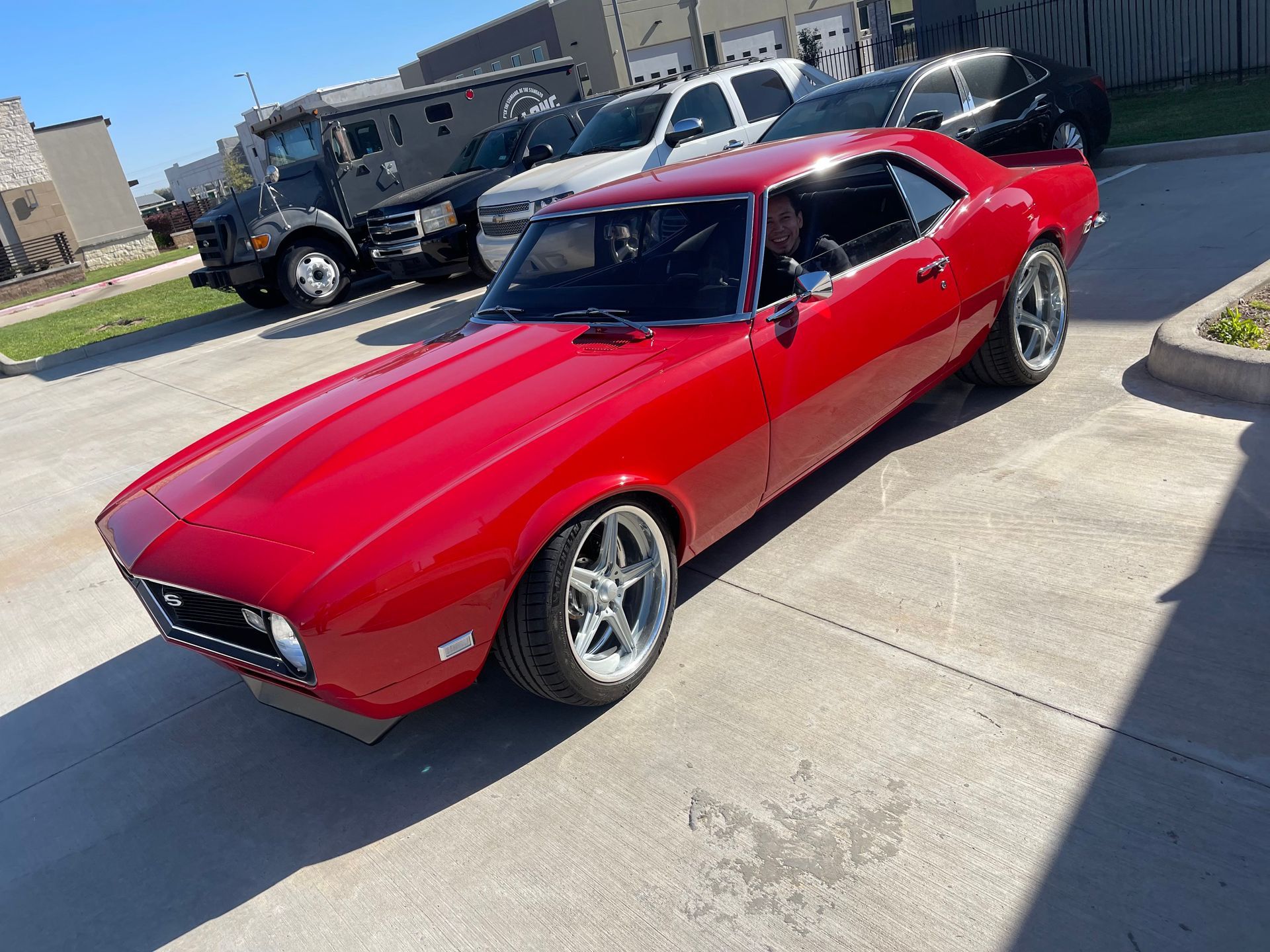 Red classic Chevy Camaro parked outside. | Auto Motive