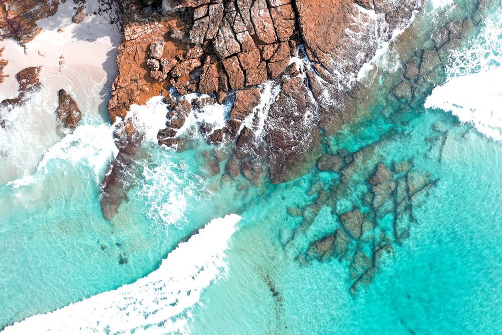 An Aerial View Of A Beach With Waves Crashing Against The Rocks There Are A Lot Of Sand Dunes In The Desert — Port Stephens Removals & Storage In Nelson Bay, NSW