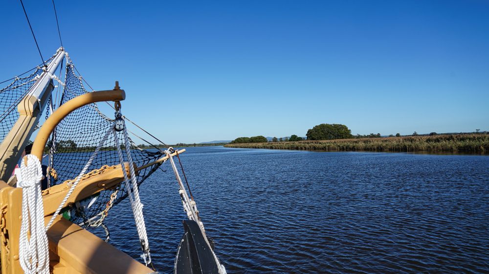 A Boat Is Floating On Top Of A Body Of Water — Port Stephens Removals & Storage In Raymond Terrace, NSW