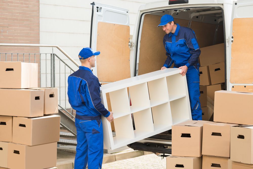 Two Men Are Loading A Shelf Into A Van — Port Stephens Removals & Storage In Salt Ash, NSW