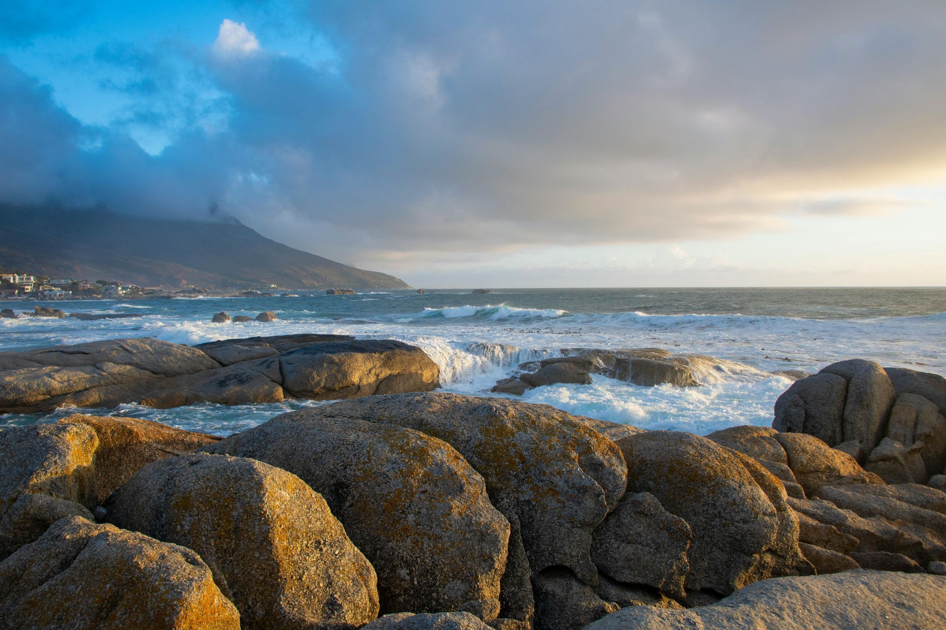A Rocky Beach With Waves Crashing Against the Rocks on a Cloudy Day — Port Stephens Removals & Storage In Stockton, NSW