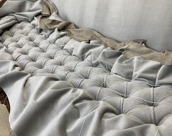 A close up of a couch with a lot of fabric on it.