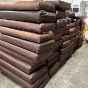 A stack of brown cushions sitting on top of each other in a room.