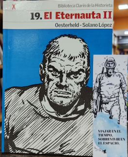 Portada del libro El Eternauta II, con el rostro ilustrado de un hombre sobre un fondo azul, y un marcapáginas a juego.
