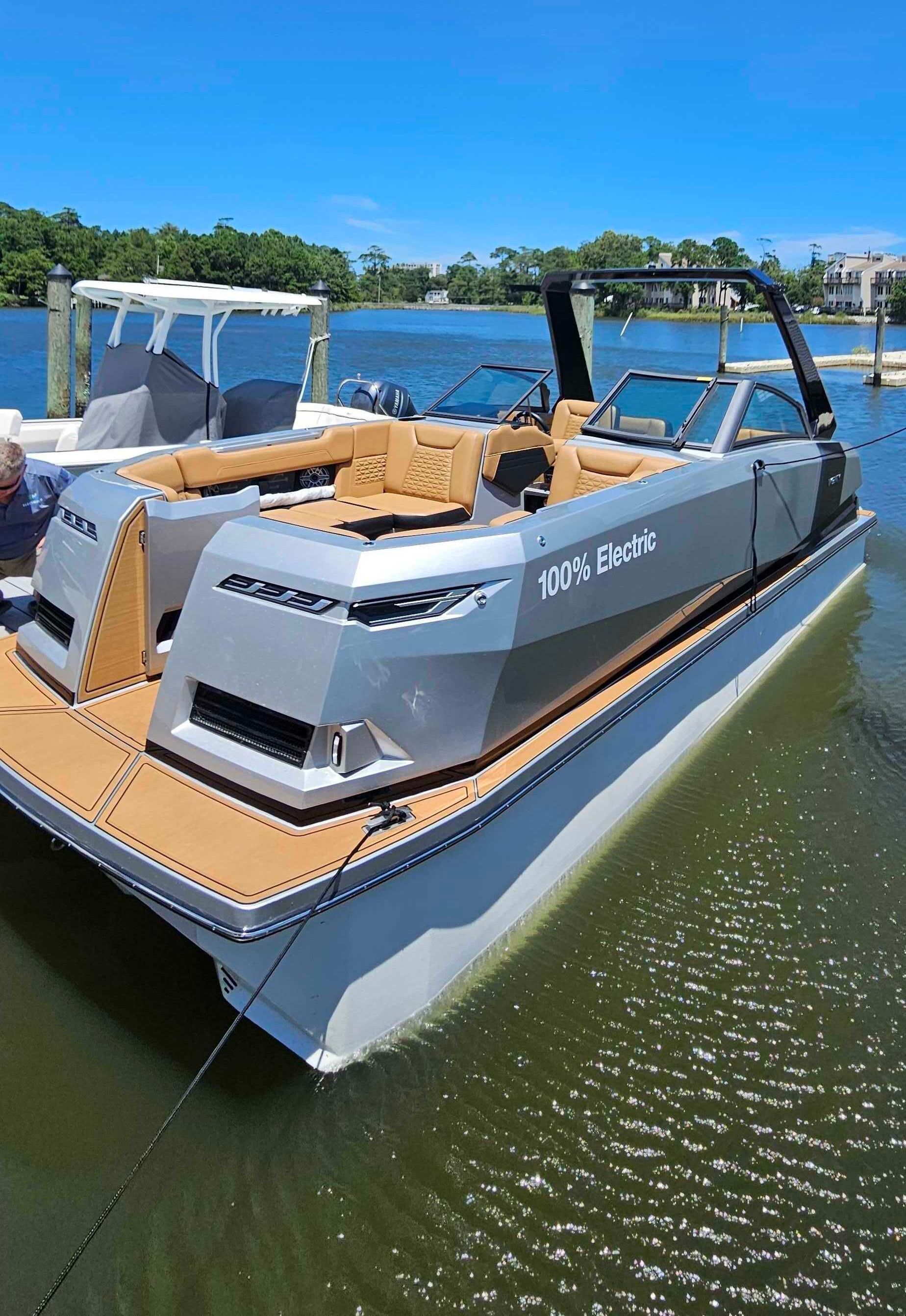 A pontoon boat is floating on top of a body of water.