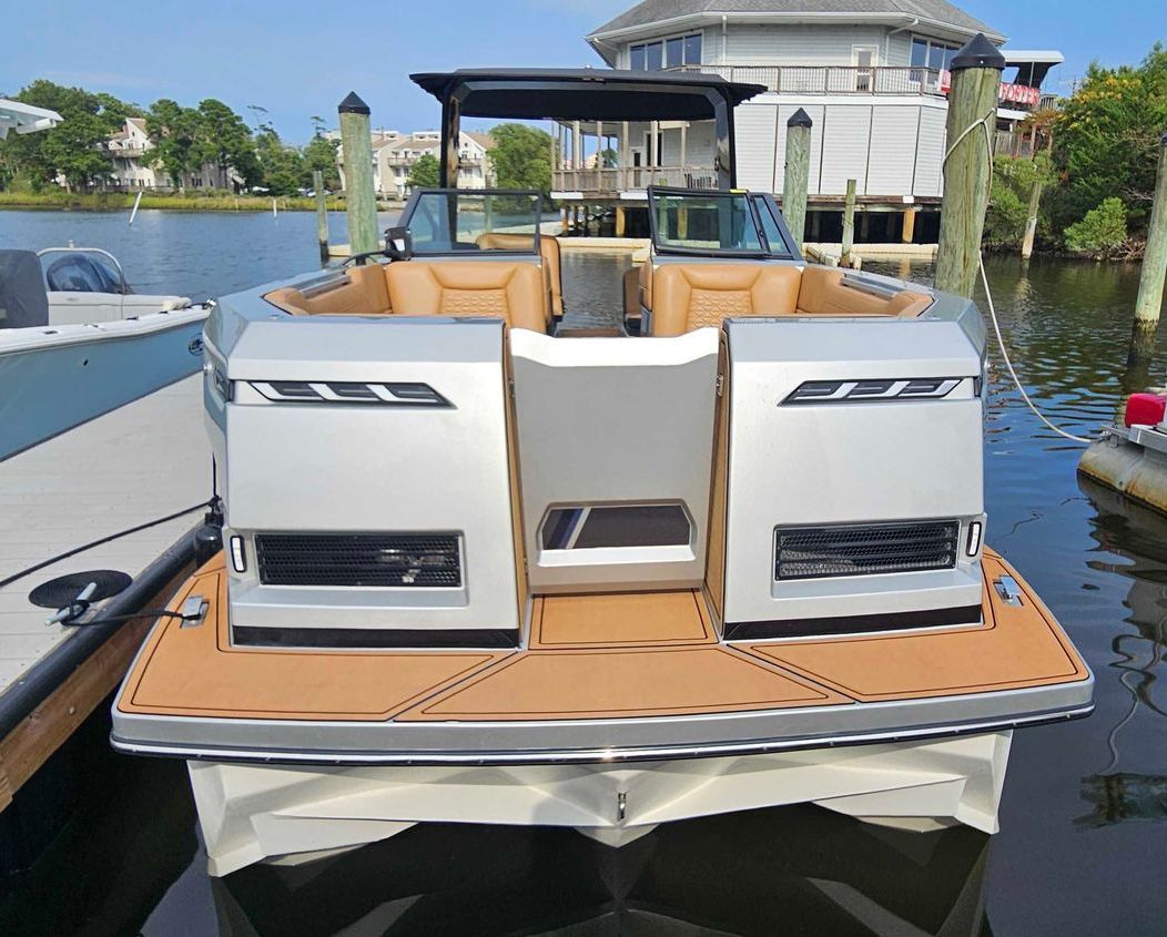 A pontoon boat is floating on top of a body of water.