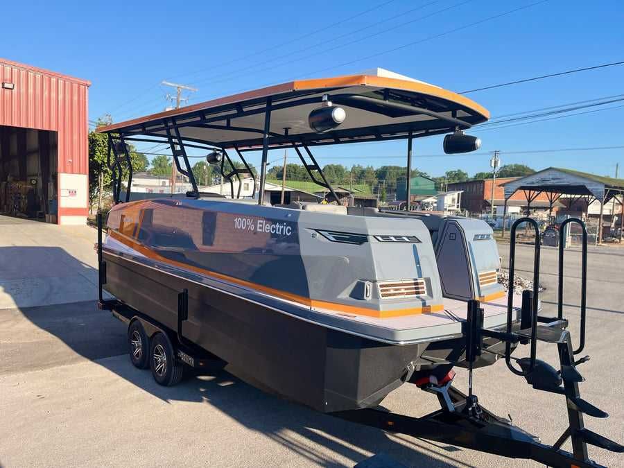 A boat is parked on a trailer in front of a building.