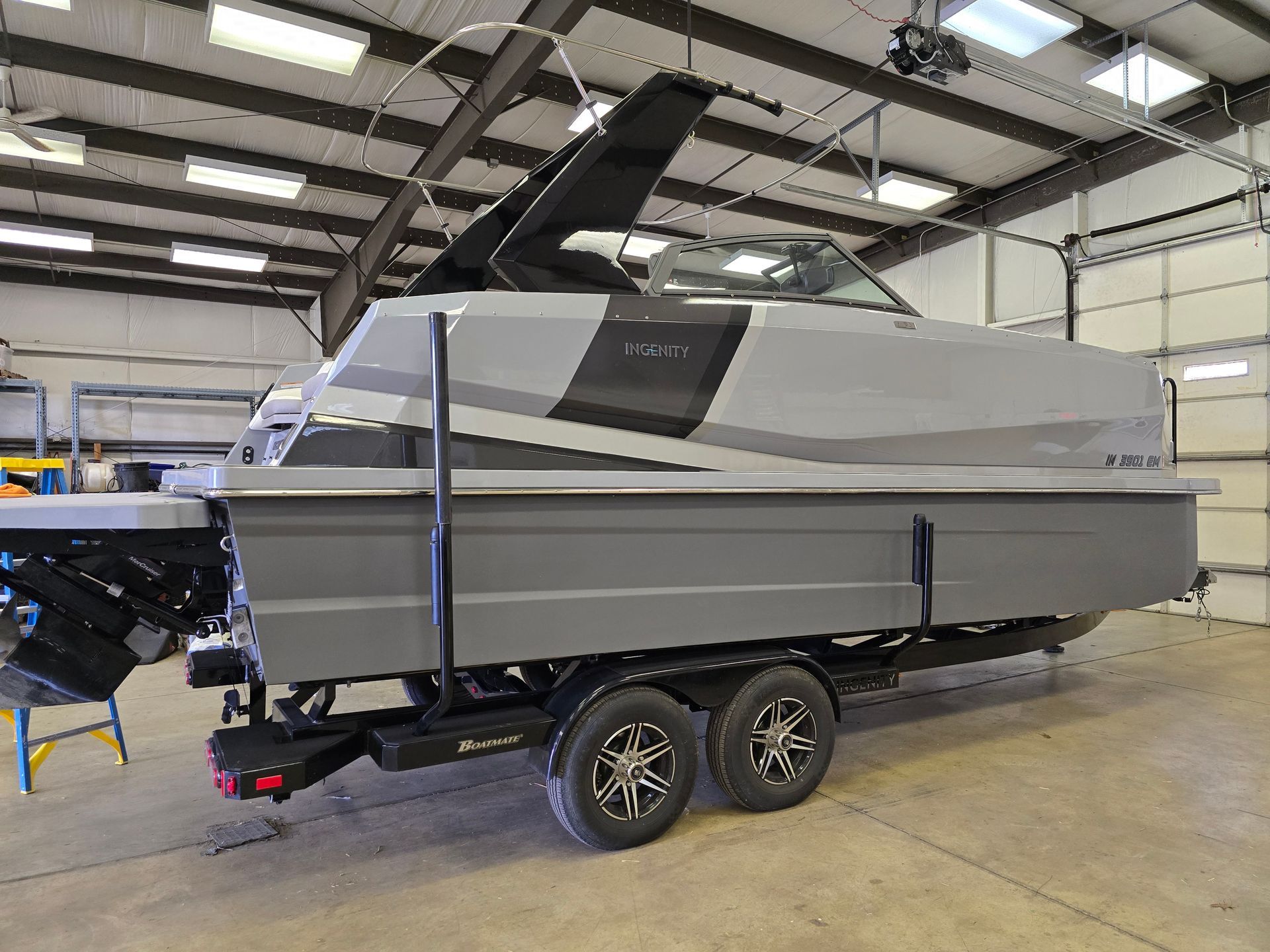 A boat is sitting on a trailer in a garage.
