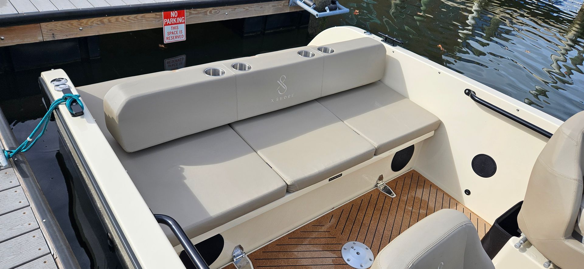 The inside of a boat with a couch and a seat.