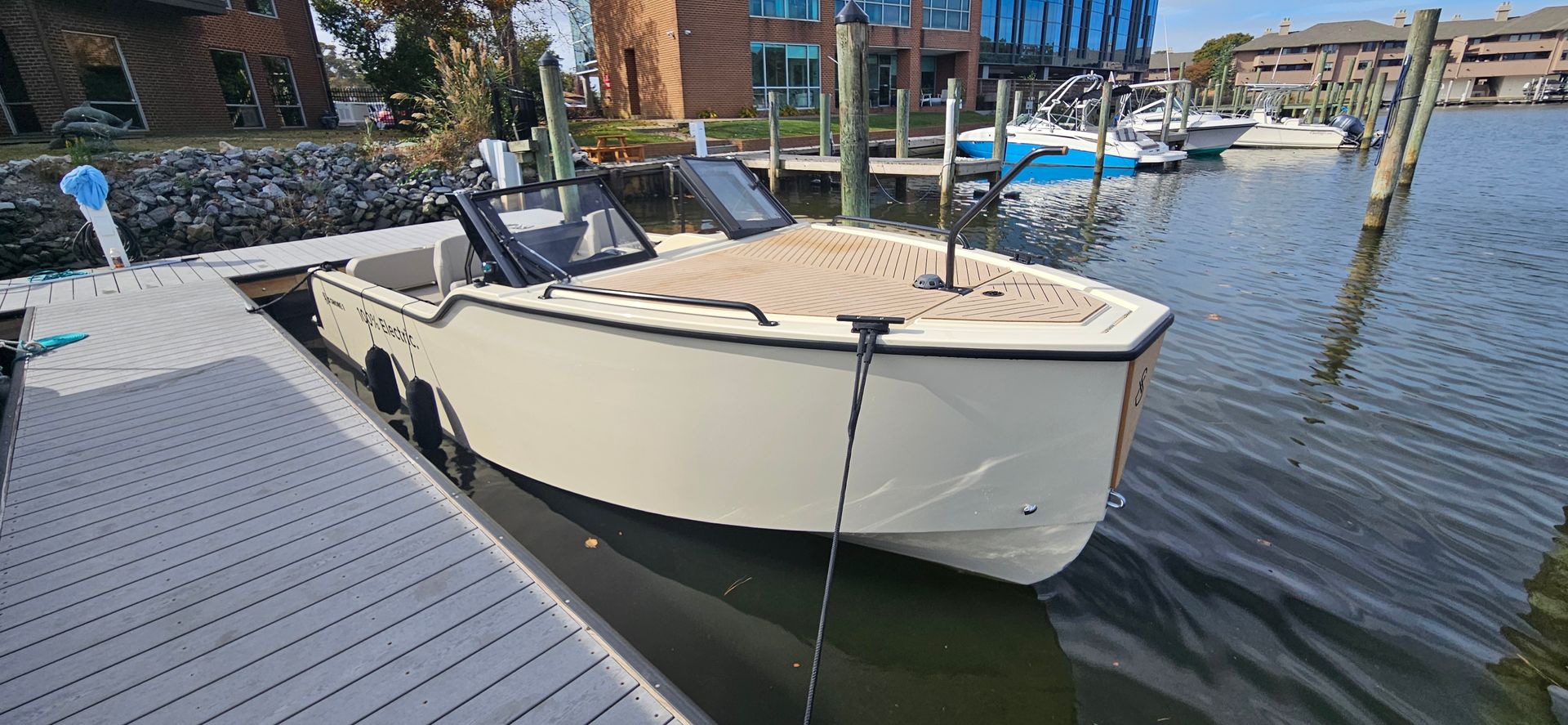 Tan boat tied to in the water, XShore One Sandy For Sale
