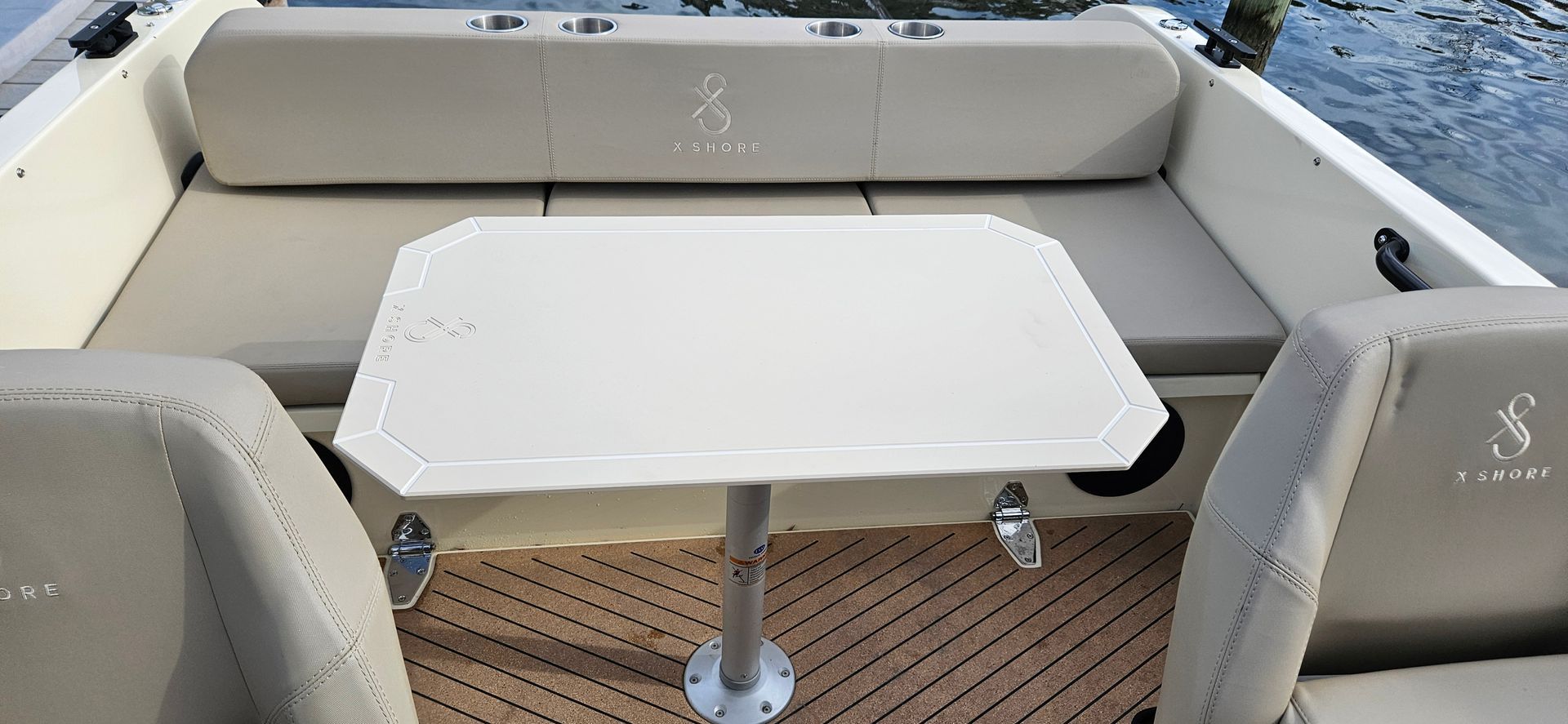 A boat with a table and chairs on the back of it.