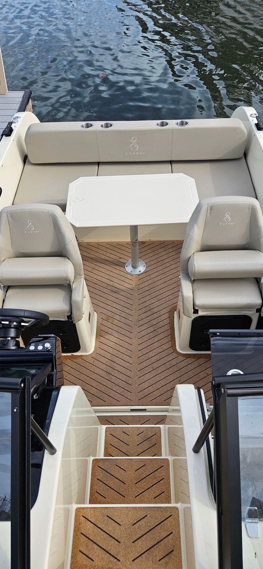 A boat with a table and chairs is docked in the water.
