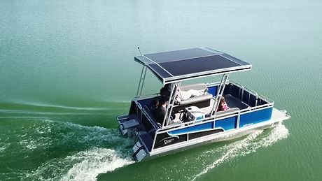 people on a pontoon that is blue and black with silver accents