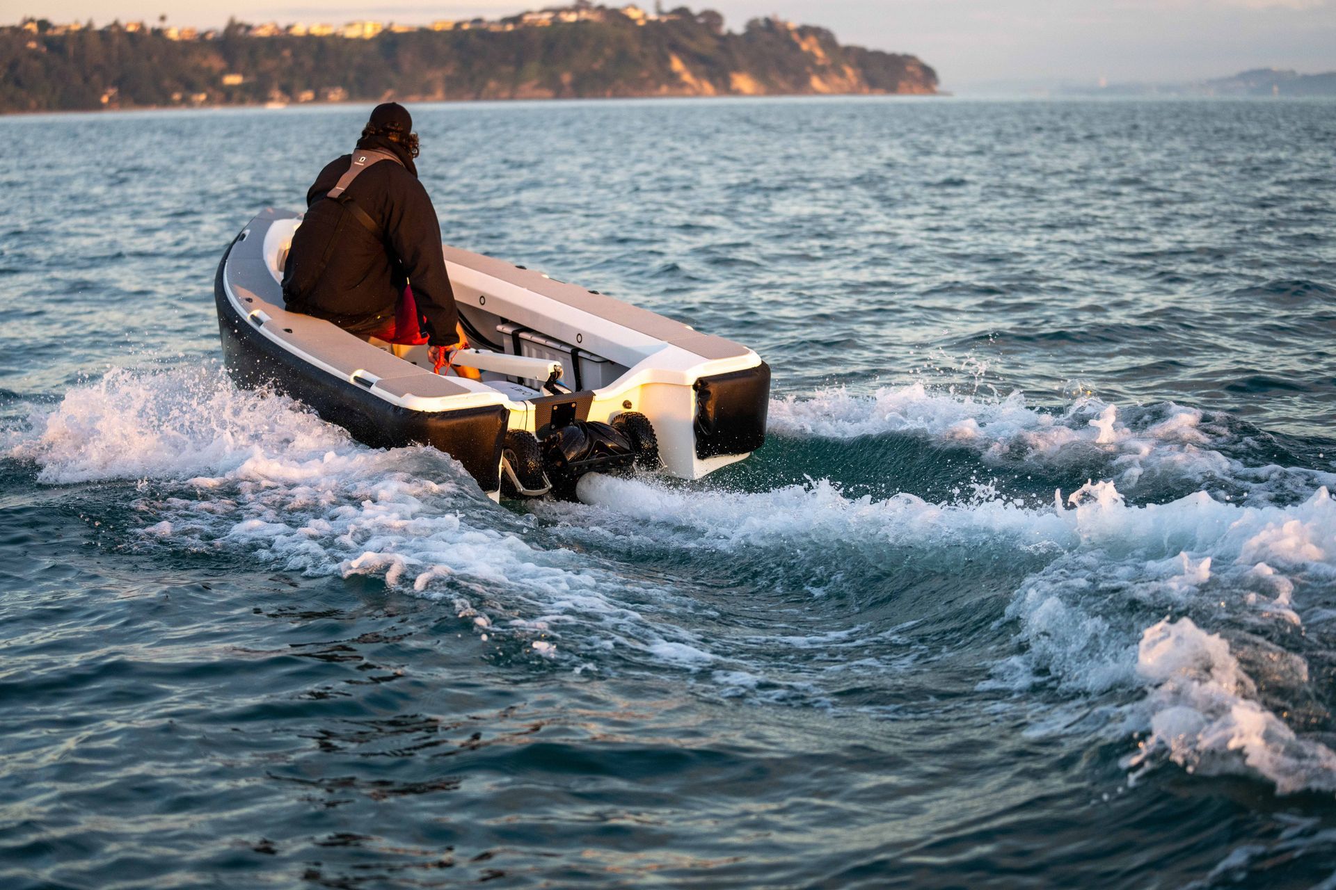Male riding the ZeroJet Powered OC tender in the ocean