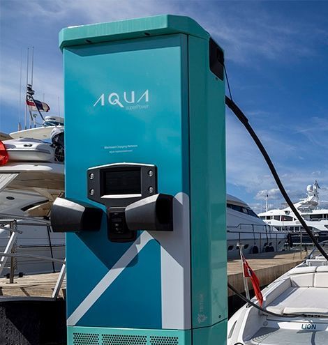 A blue aqua charging station is next to a boat
