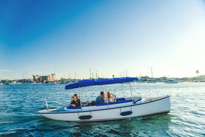 A couple enjoying a sunset cruise on a white gondola-style boat