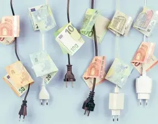 A bunch of money is plugged into a power cord.