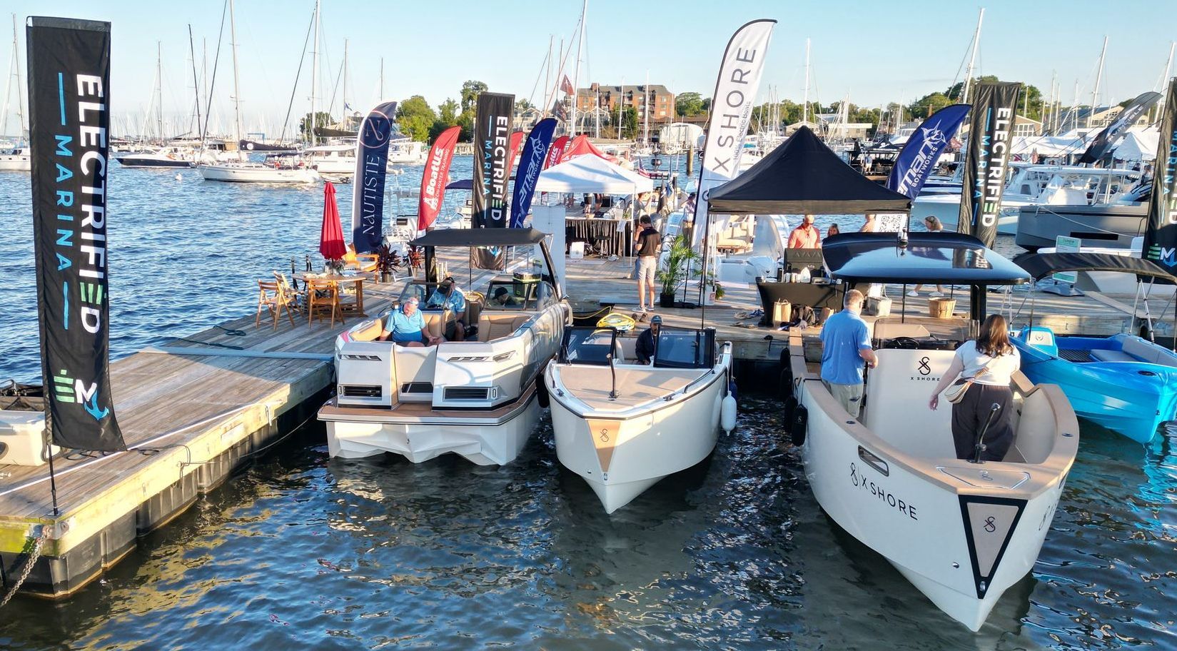 A group of boats are docked at a marina.
