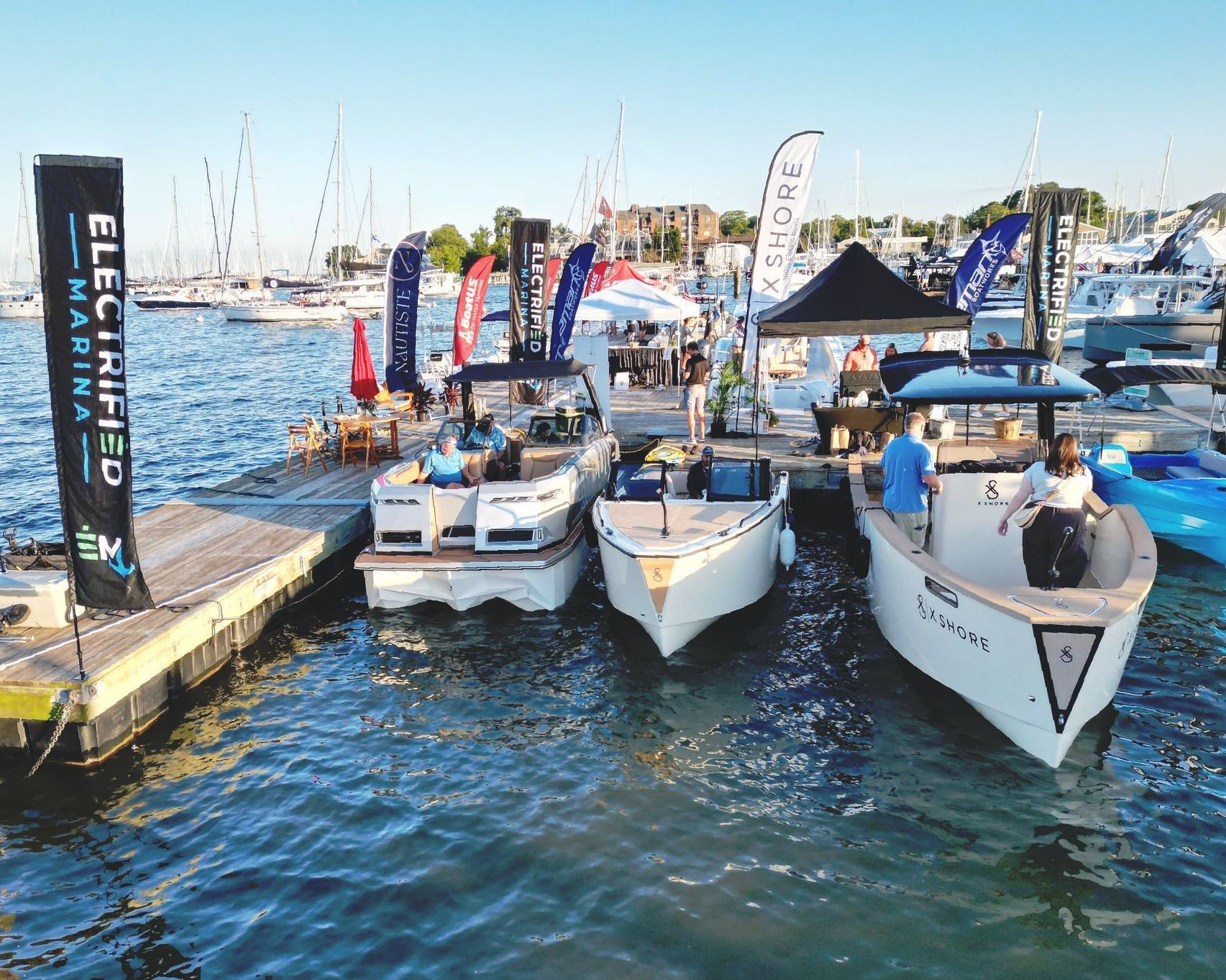 A group of boats are docked at a dock.