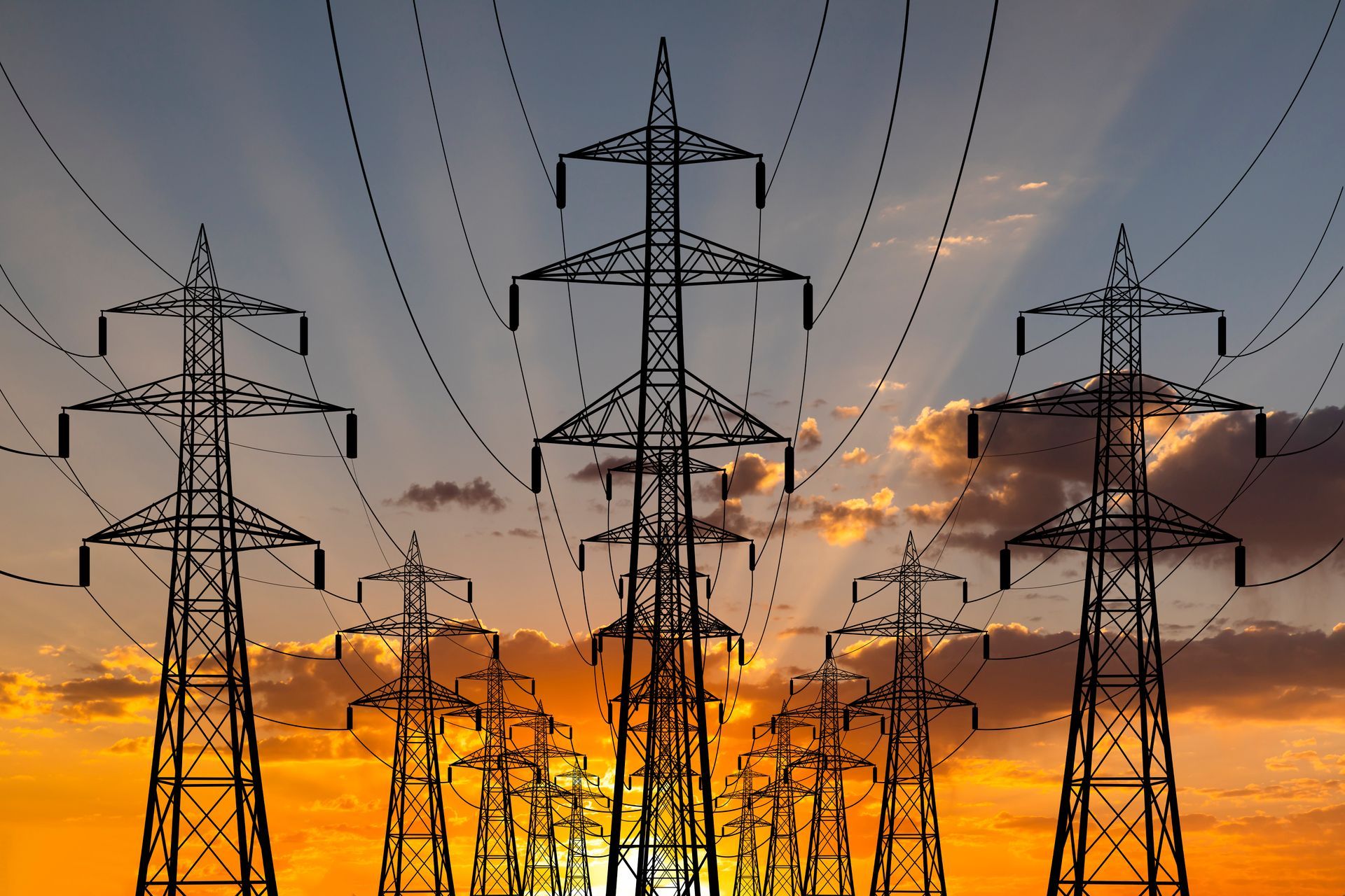 A row of power lines against a sunset sky