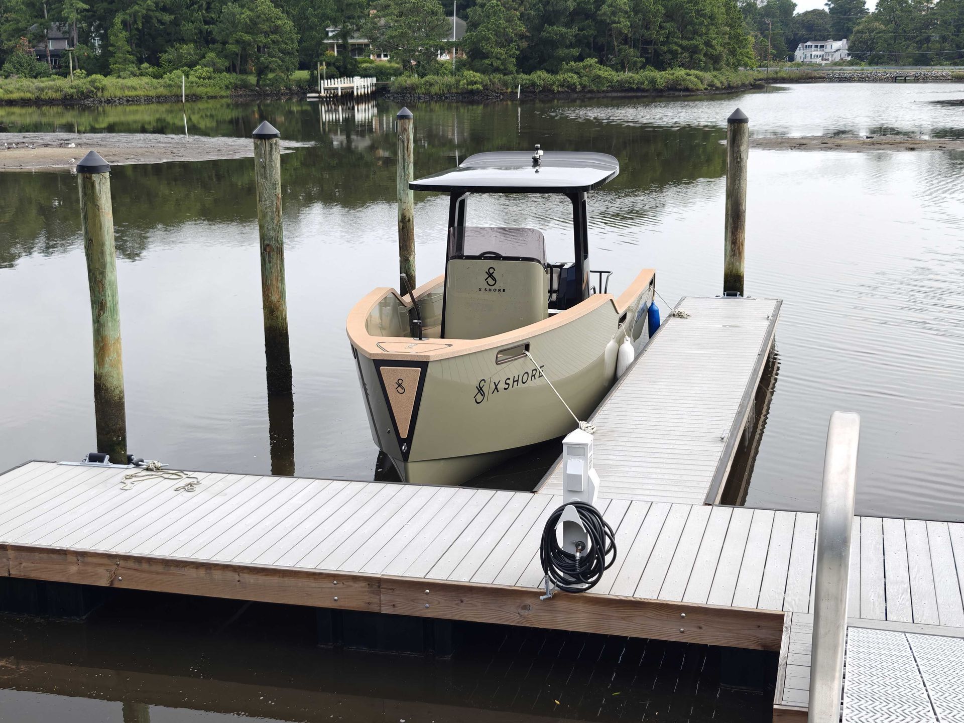 A boat is docked at a dock with a license plate that starts with the letter a