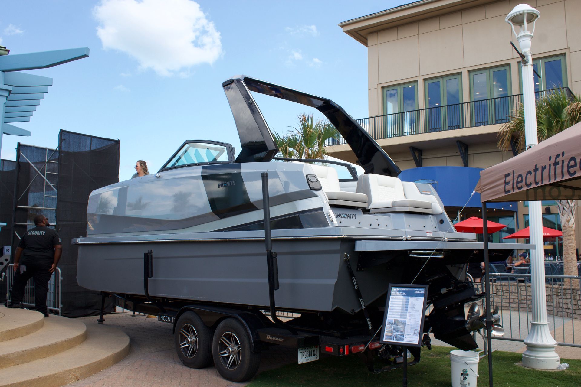 A boat is parked on a trailer in a garage.