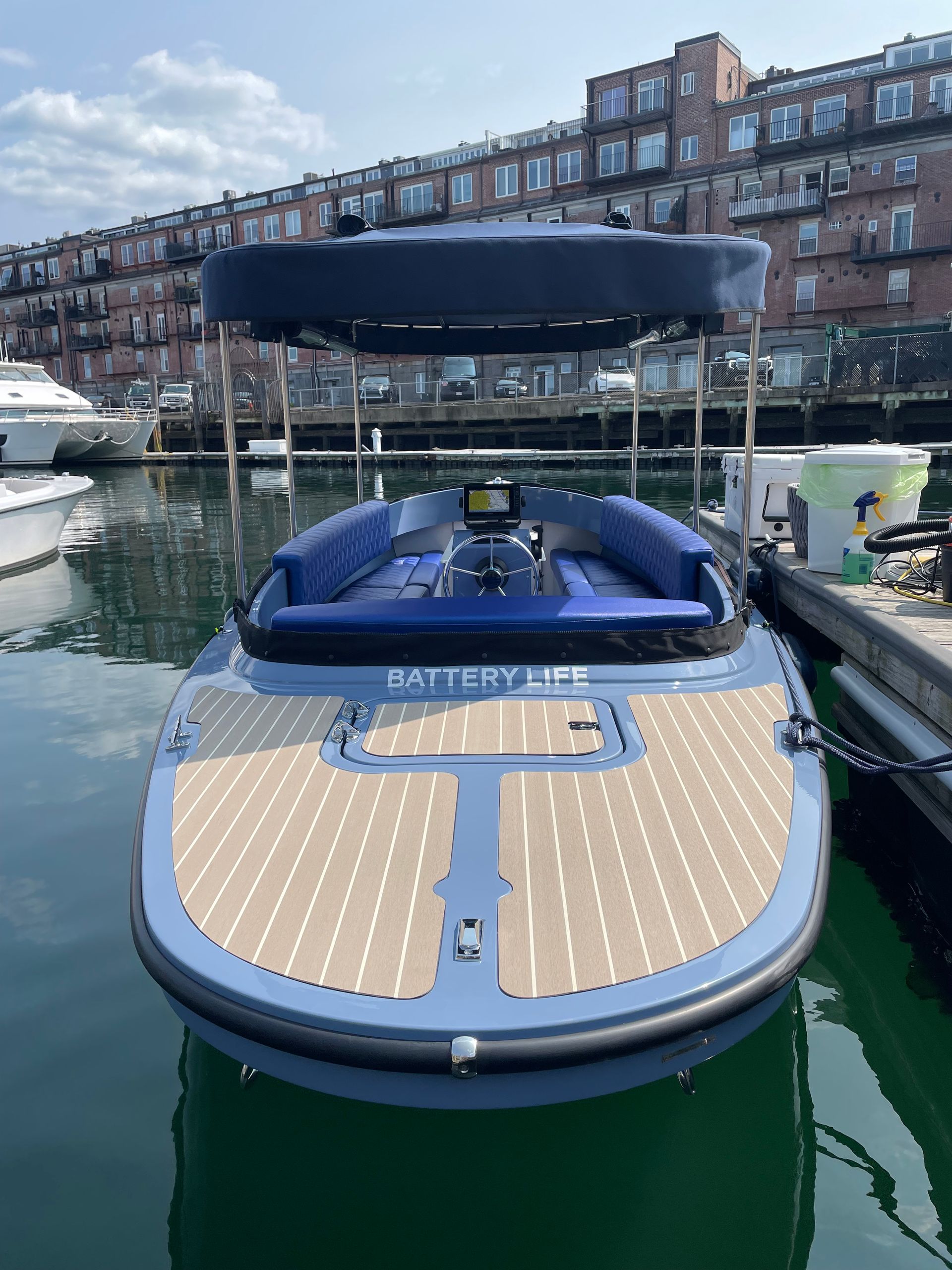 Fantail with a tan canopy is docked at a dock