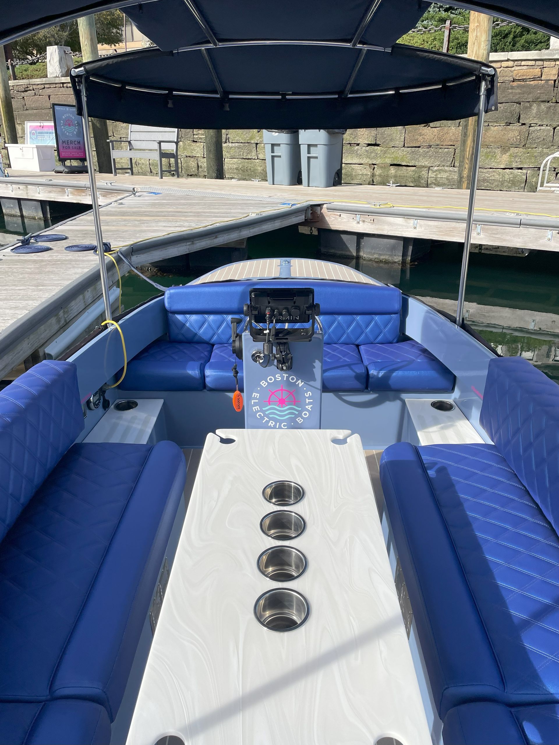 inside Fantail 217 seating layout with table blue seats and blue interior 4 cupholders on boat