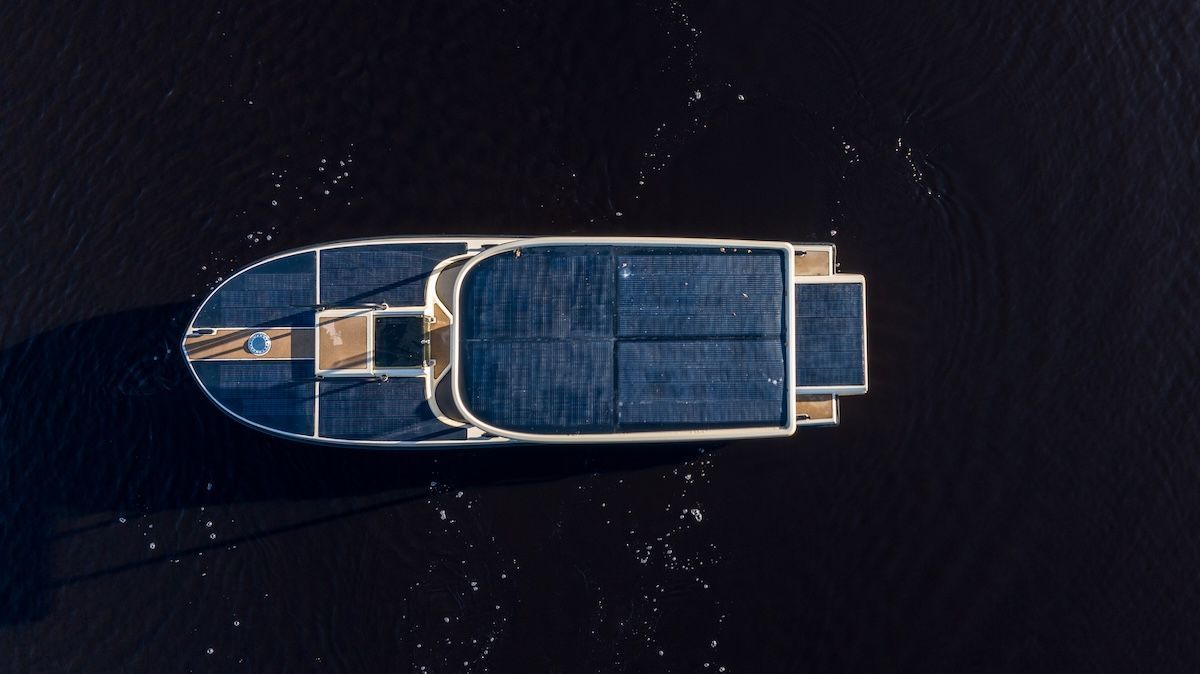 Birdseye view of Amber from Elvene, runabout boat covered in solar panels on the center console top and decking of the boat.