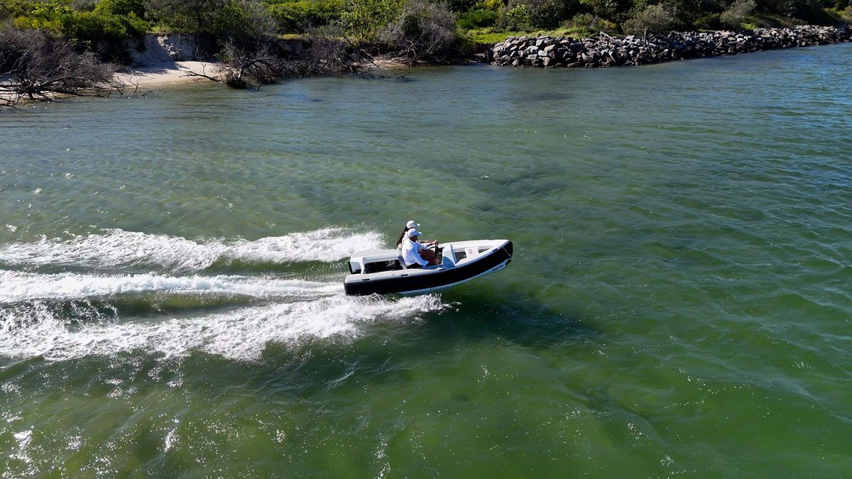Couples riding the ZeroJet Powered OC tender in the ocean