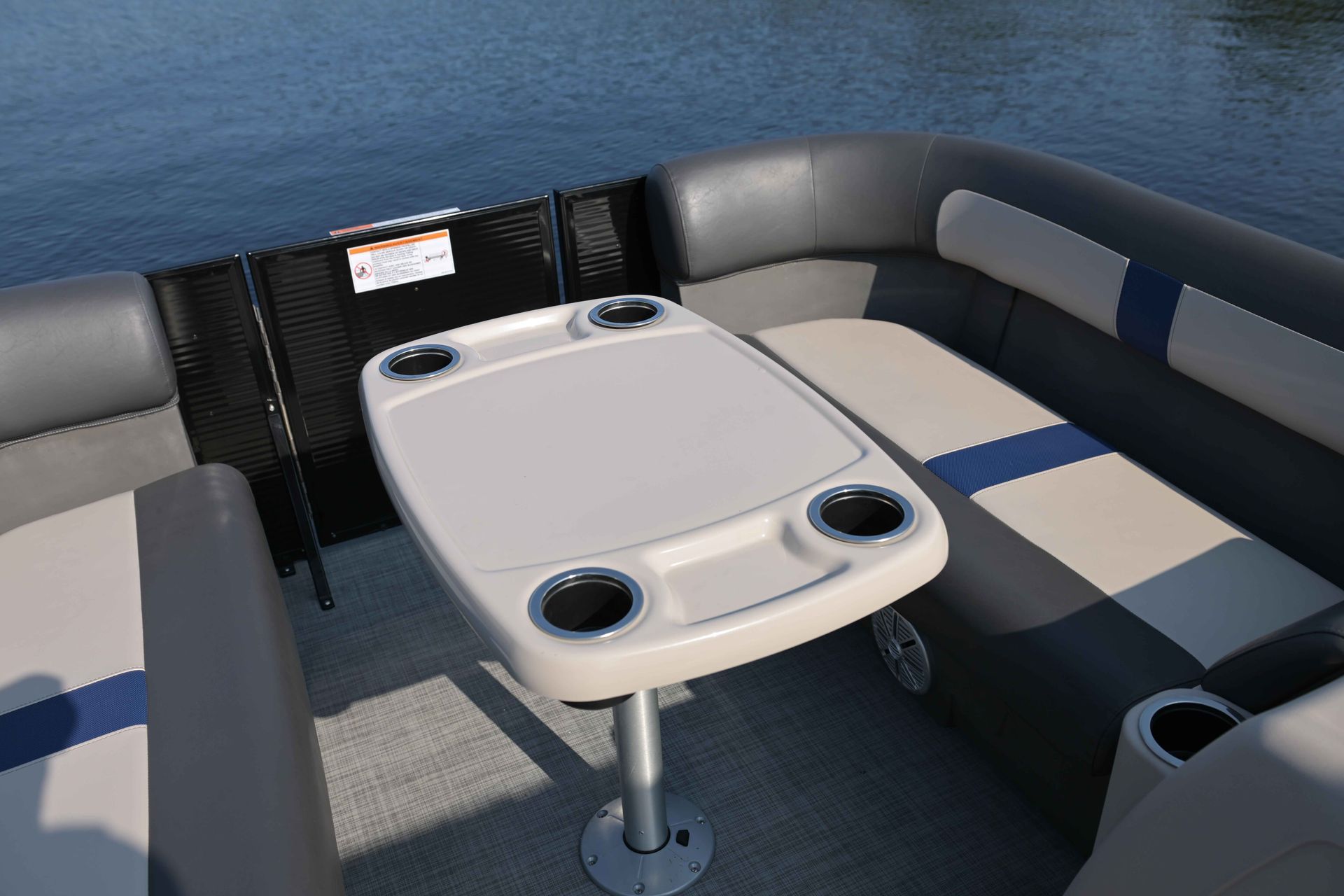 Plastic table with 4 cupholders on a stand on a pontoon color beige