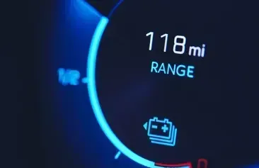 A close up of a digital display that says 118 mi range