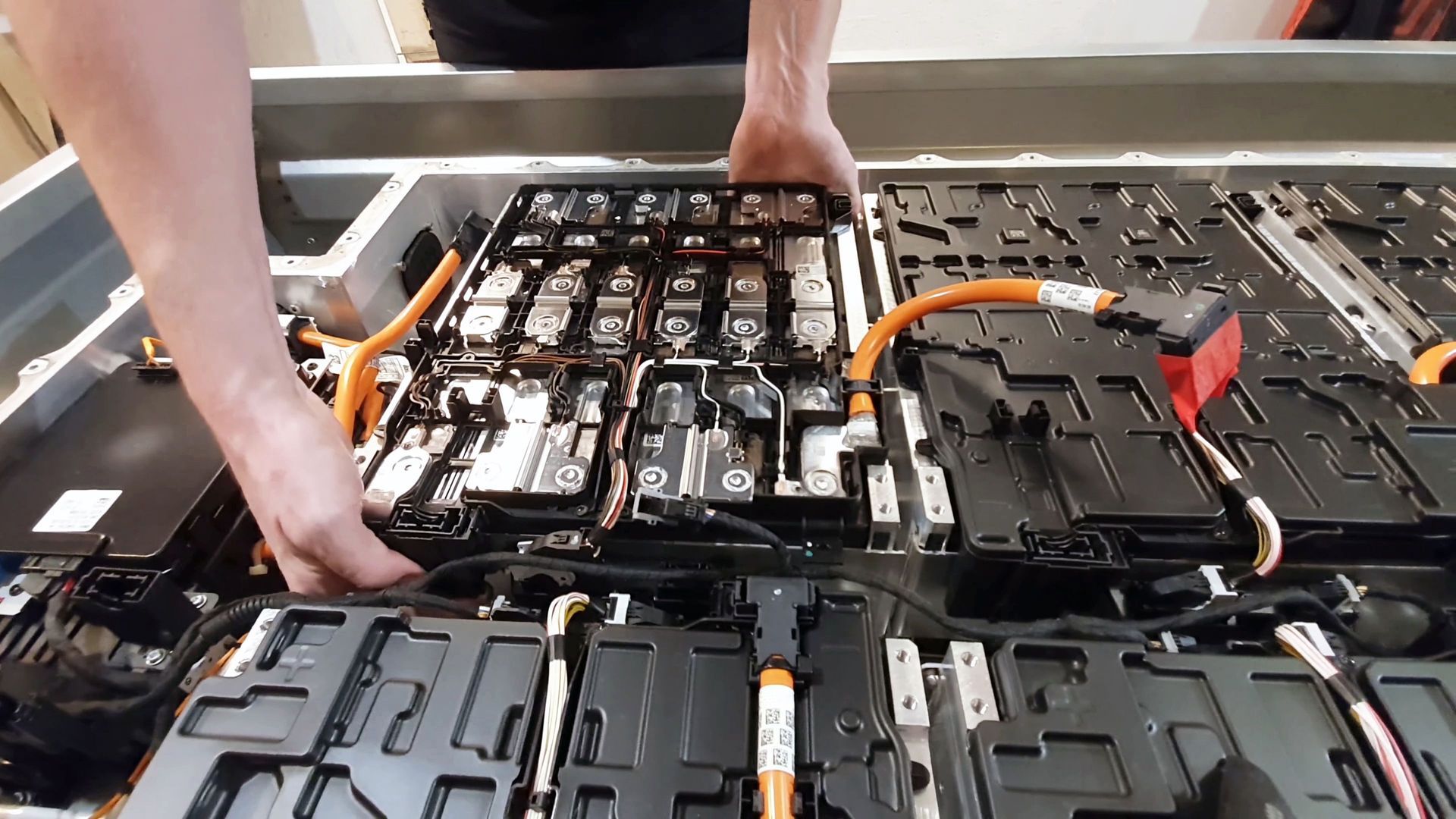 A person is working on a lithium ion battery.