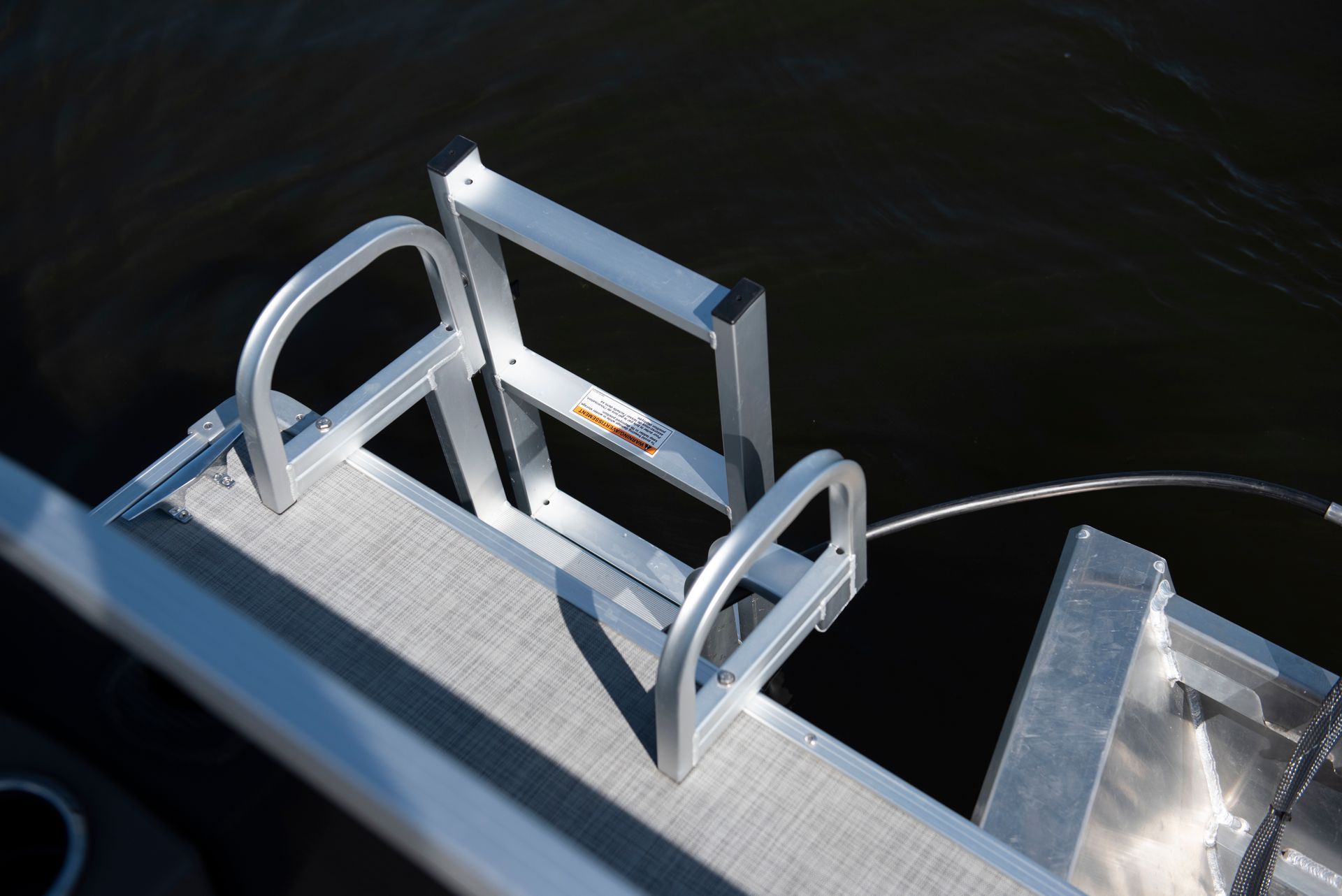 swim ladder on the back of a pontoon in the water