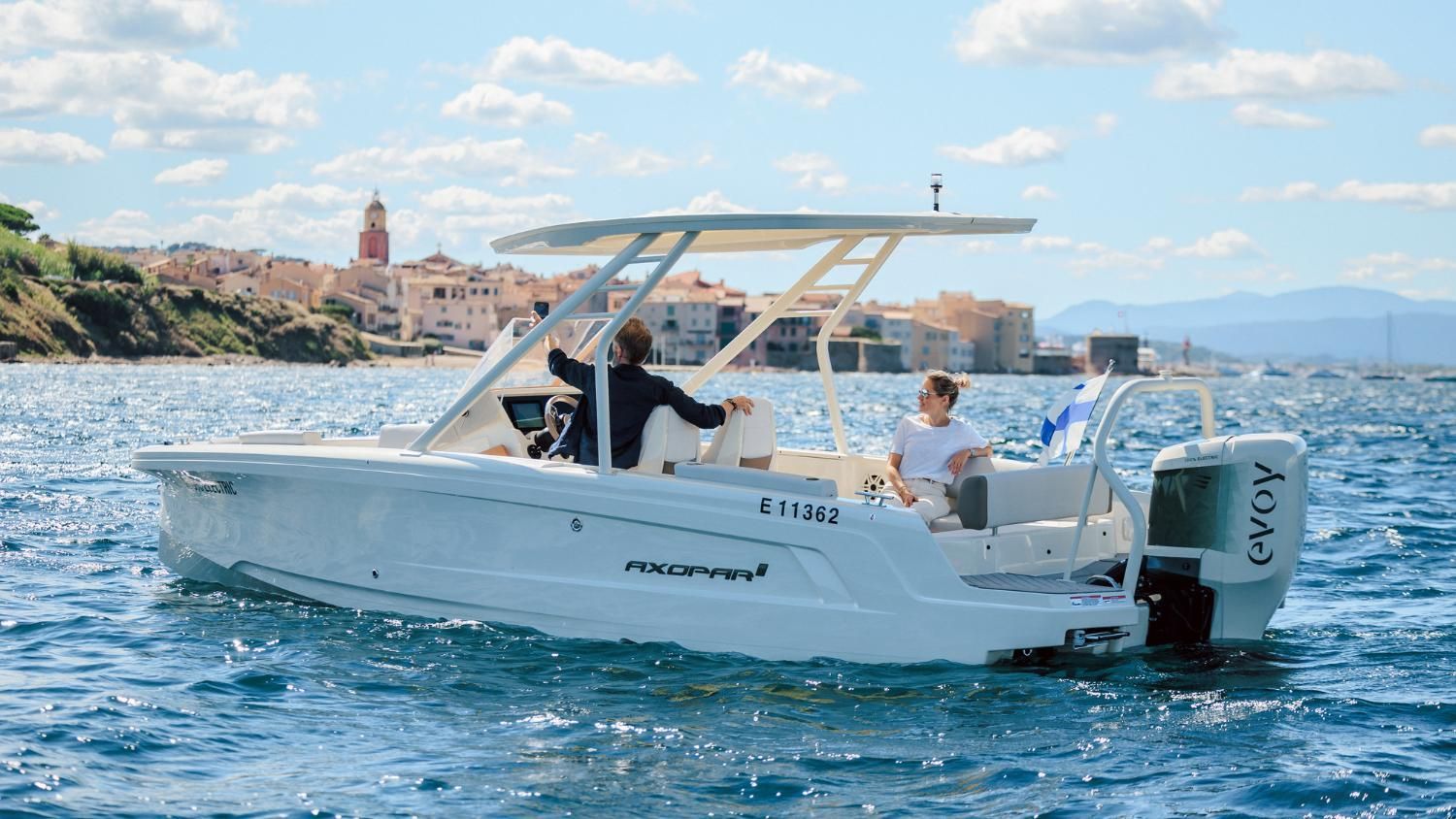 A white boat is floating on top of a body of water.