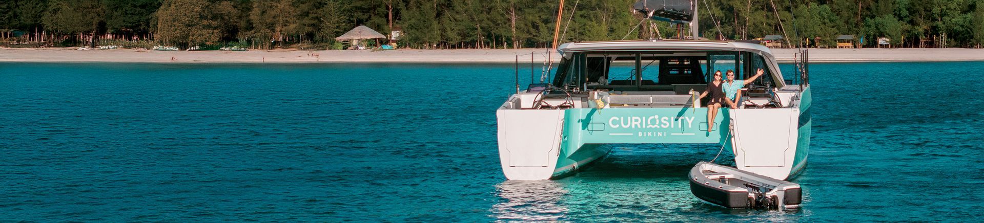 FourWynns HH Catamaran with OCT tender at stern in tropical water