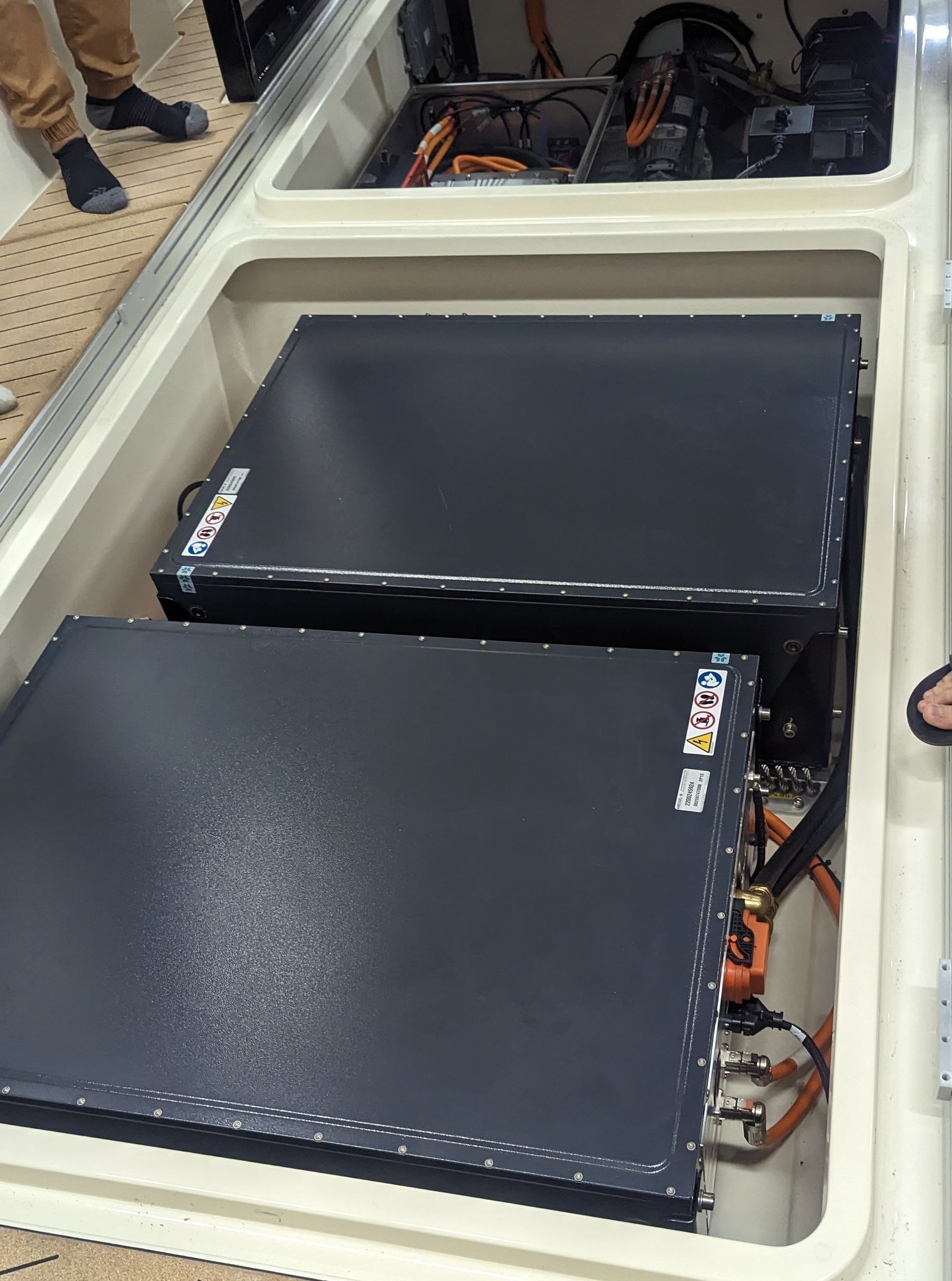 Two black boxes are sitting in a white box on top of a table.