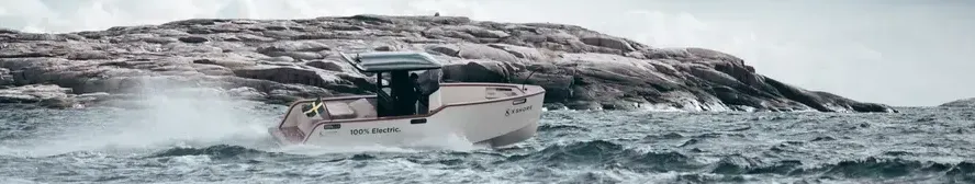 A boat is floating on top of a large body of water.