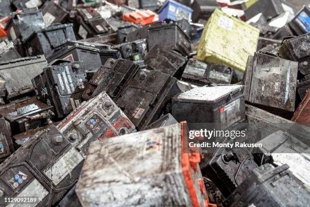 A pile of old batteries sitting on top of each other.