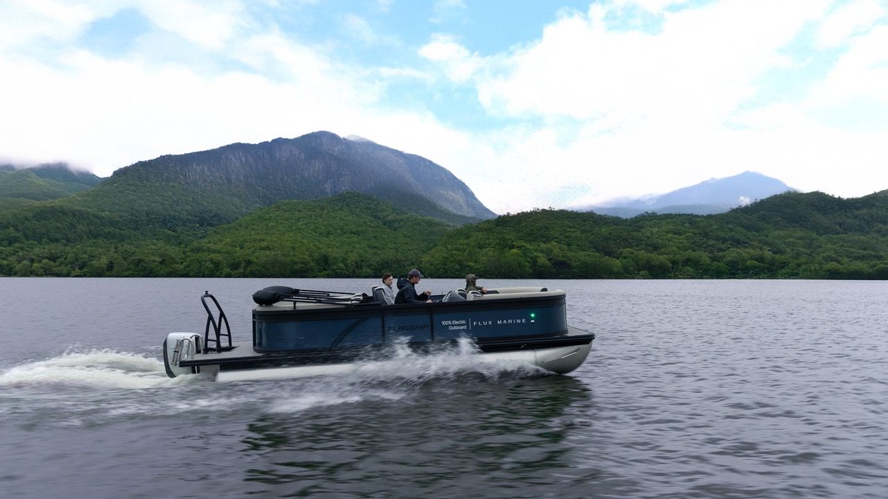 A gray and white trimaran boat cutting through the water