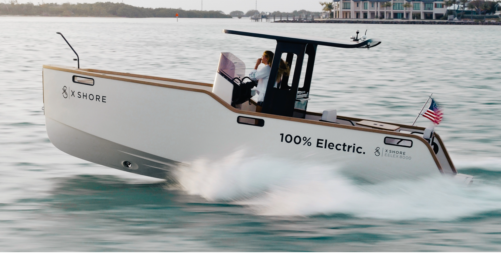 A white boat is floating on top of a body of water.
