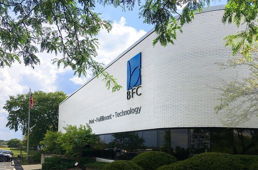 Office building with an LFC logo and “information technology” sign, framed by trees and shrubs